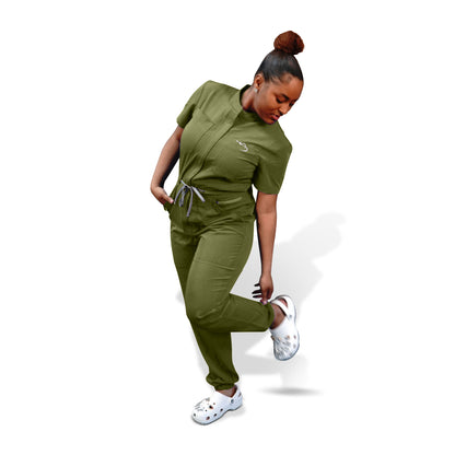 A woman modeling the green scrubs romper from House of Scrubs. The romper is green in color, has a V-neckline, short sleeves, and the woman is wearing white shoes.